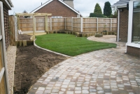 Rustic sett paving linking to lawn edging