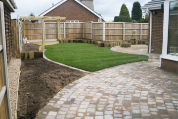 Rustic sett paving linking to lawn edging